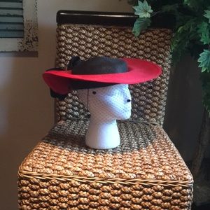 Red and Black hat with a black net veil in front.